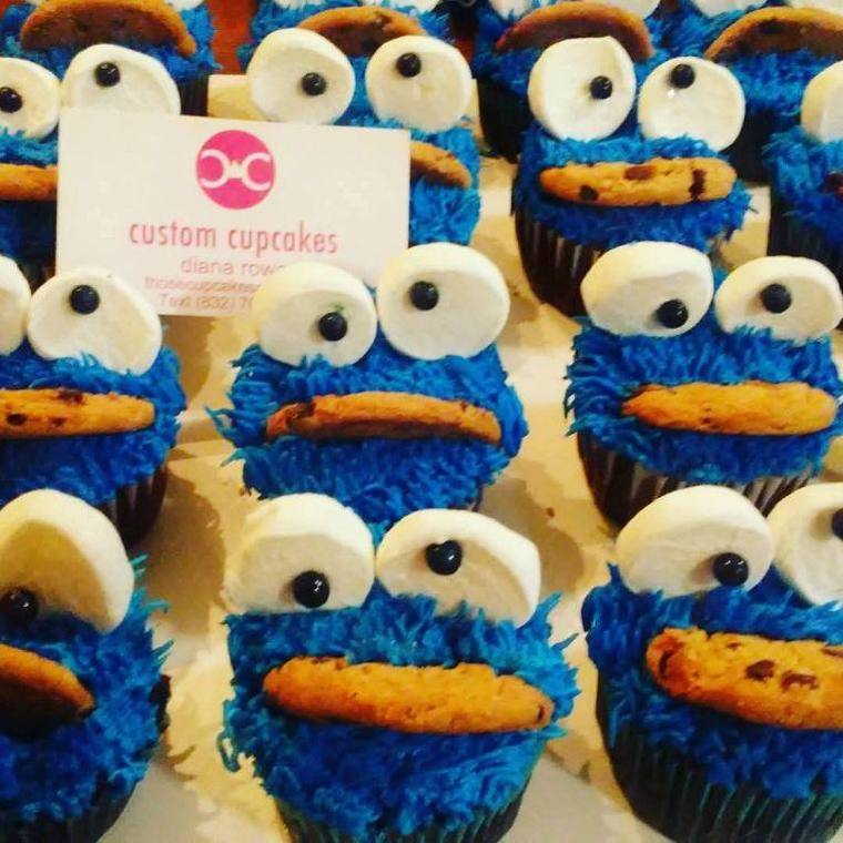 Blue Cookie Monster cupcakes with marshmallow eyes and a chocolate chip cookie in each mouth
