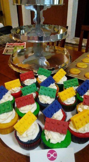 LEGO brick cupcakes in six colors on a tiered silver stand